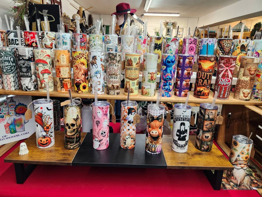 A rack of printed tumblers and drinkware made by a local vendor