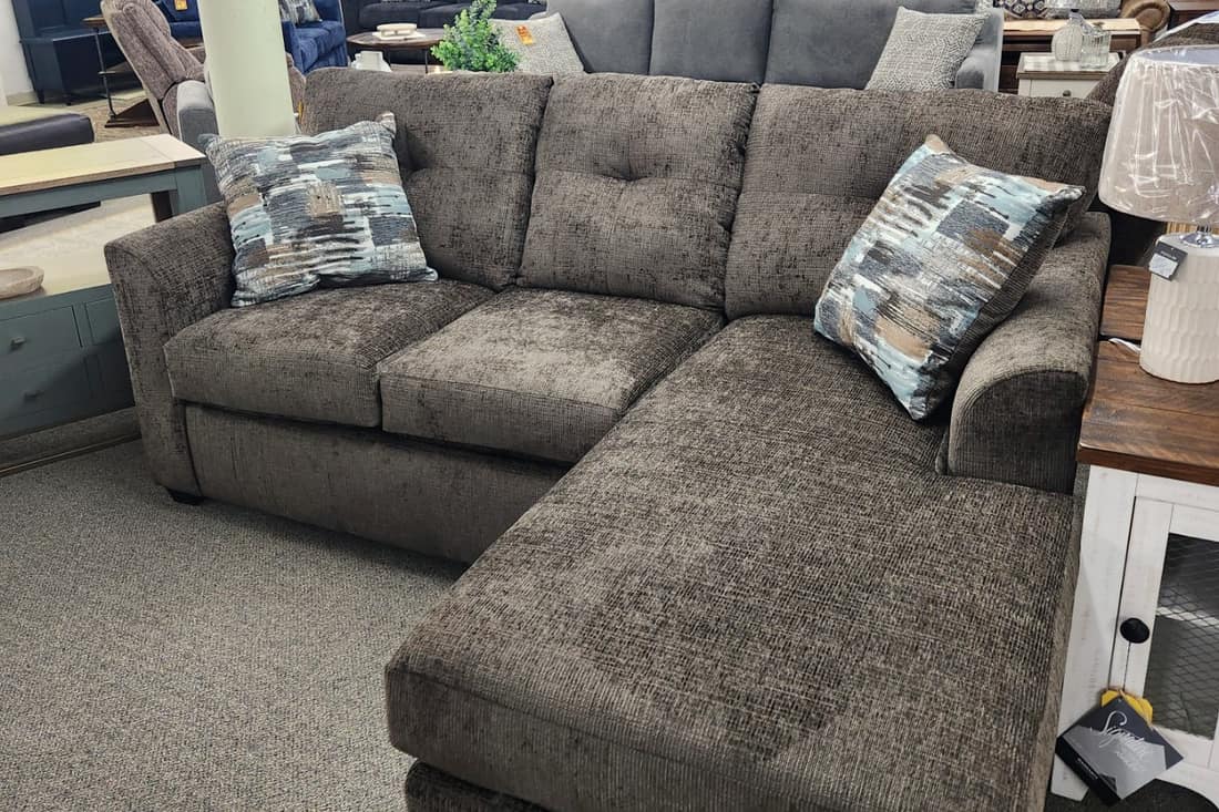 A large taupe chenille chaise sectional on the first floor at Thieves Market