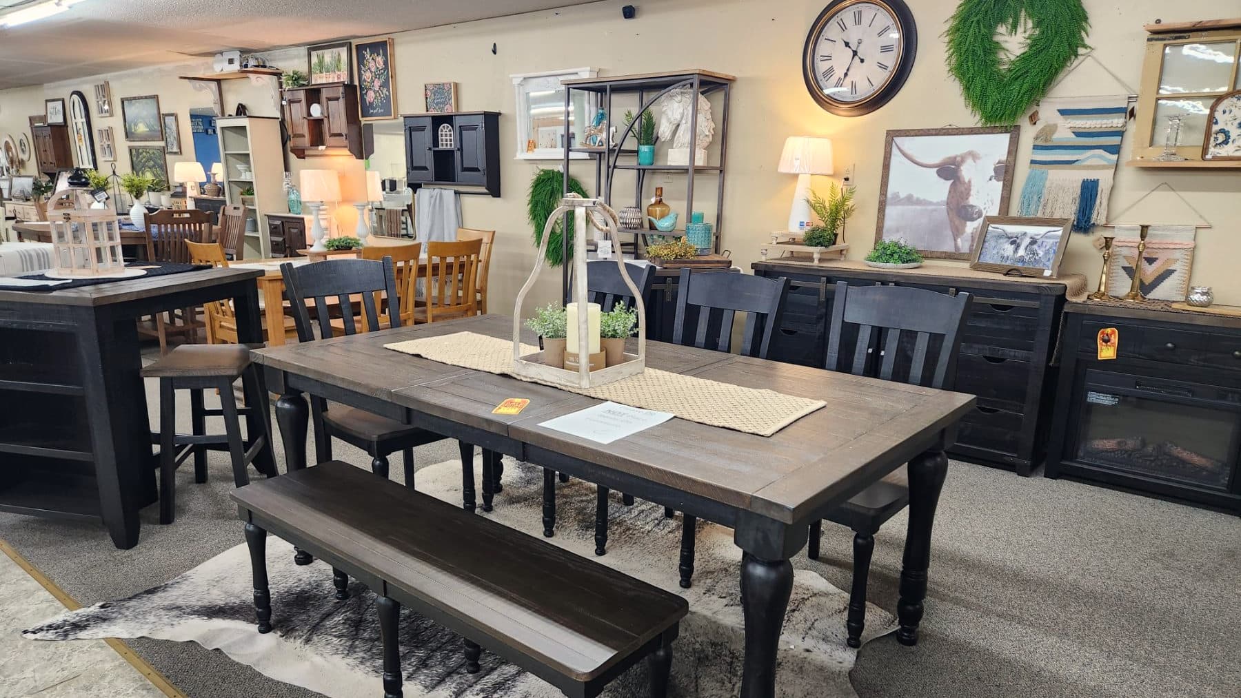 Dining tables, benches and a wall of framed art and mirrors on the first floor of Thieves Market in Philipsburg
