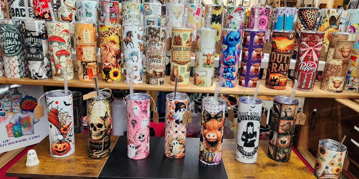 A rack of printed tumblers made by a local vendor in a booth upstairs at Thieves Market