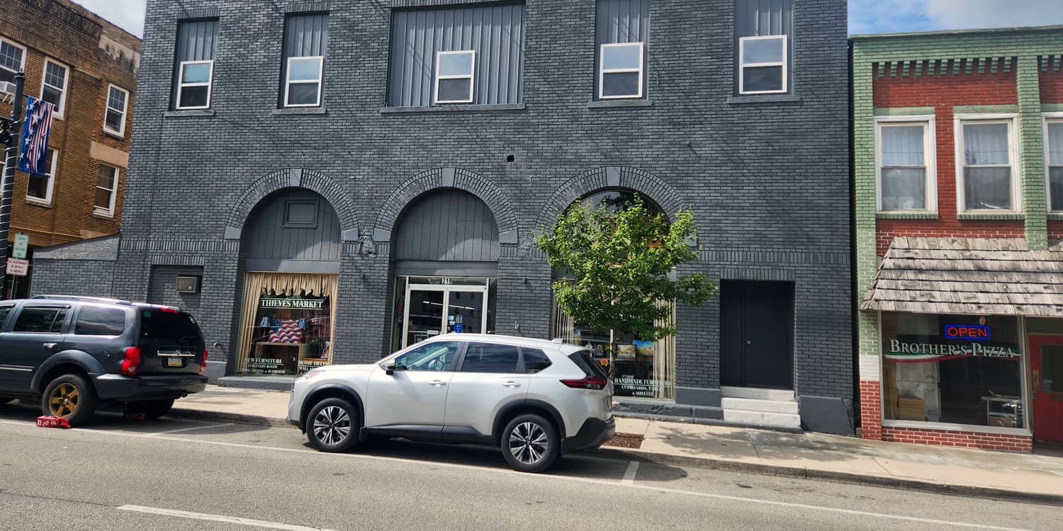 The grey brick front of Thieves Market at 219 N Front Street in Philipsburg