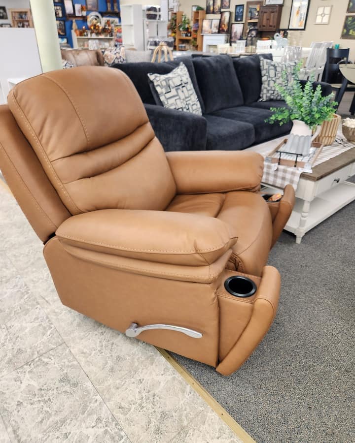 A tan leather power recliner with a cup holder in the arm, standing on the first floor at Thieves Market