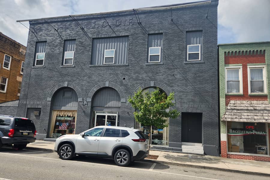 The grey brick front of the Thieves Market building on Front Street in downtown Philipsburg